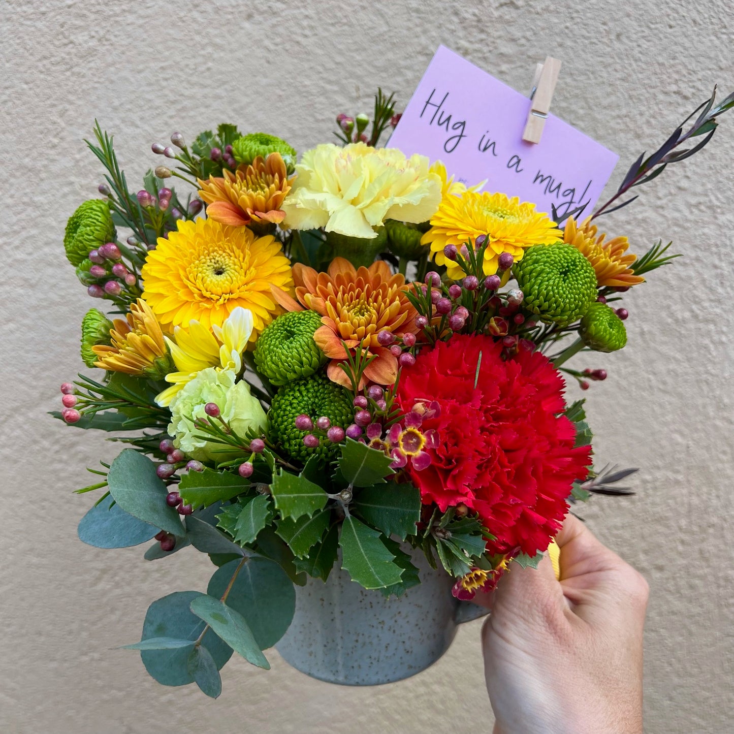 A bright hug in a mug arrangement.