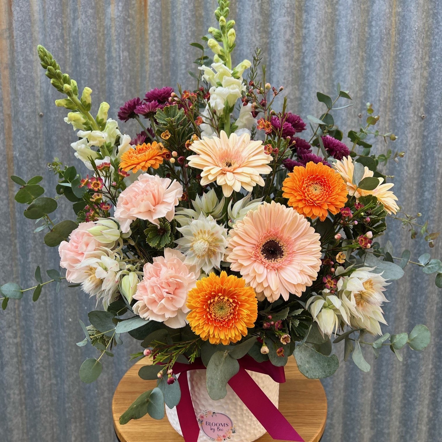 A pastel bloom arrangement in a ceramic pot